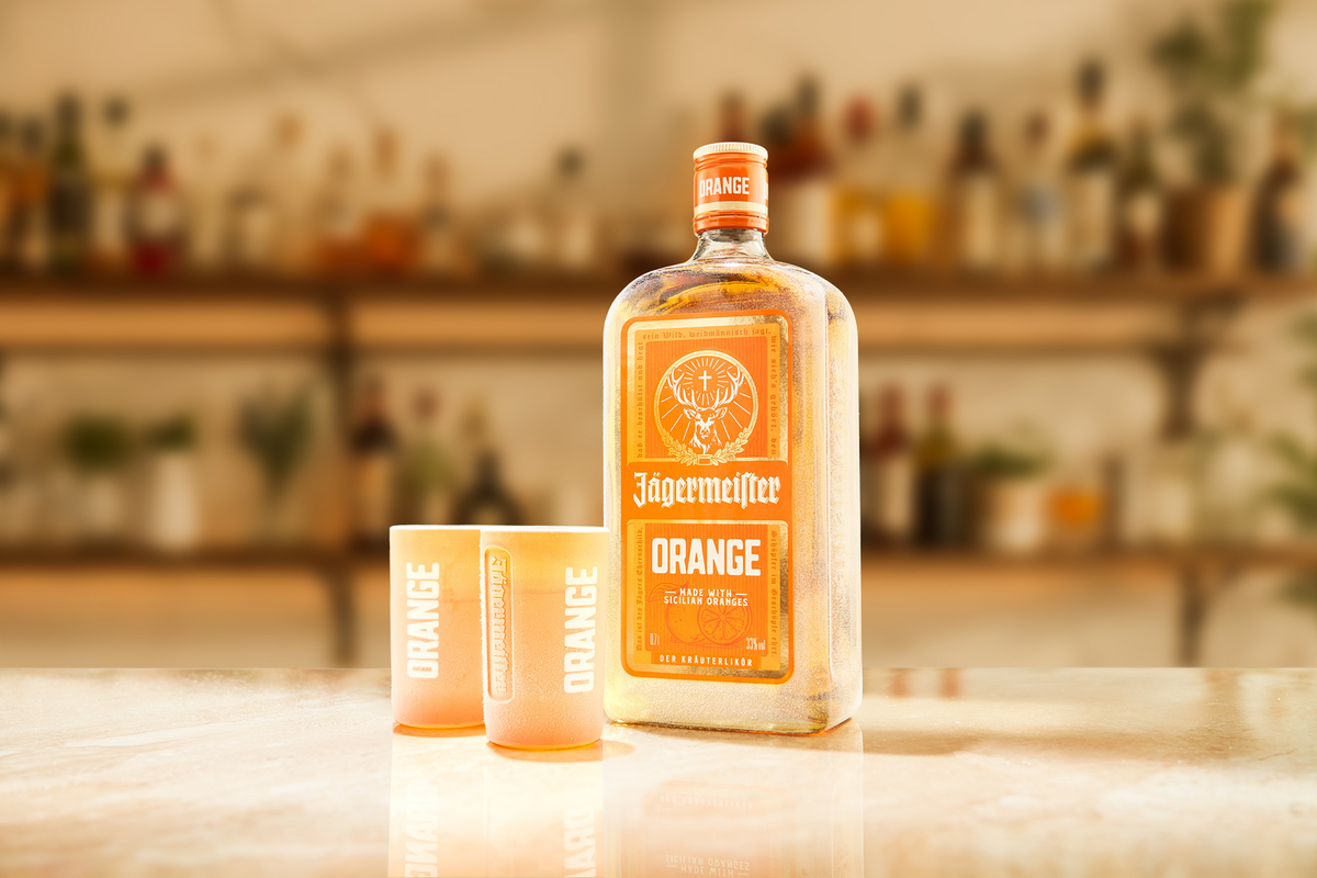 Jagermeister Orange bottle with two shot glasses on a bar counter
