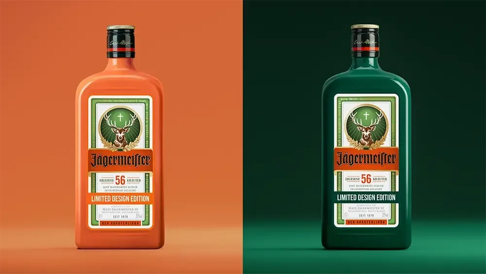 Two Jägermeier 56% alcohol-free spirit bottles shown side by side on a split orange and dark green background. The left bottle is orange with a cream and green label, and the right bottle is dark green with a matching cream and green label.
