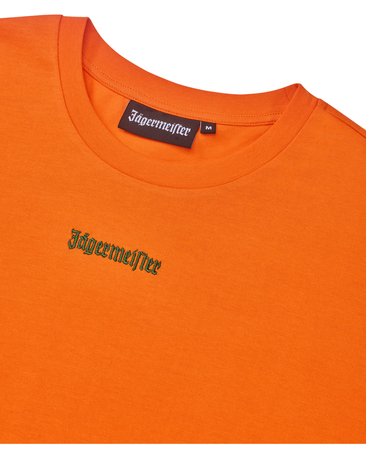 Narancssárga cropped tee zöld Jägermeister logóval.
