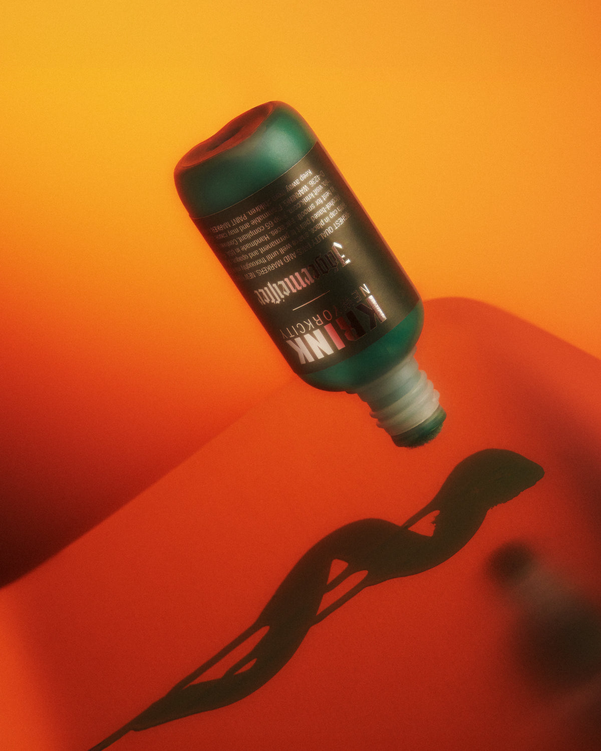 Zöld Krink marker Jägermeister márkajelzéssel, piros és narancssárga átmenetes háttéren